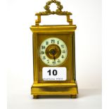 An antique brass French carriage clock with enamelled dial, H. 16cm (appears to be in working