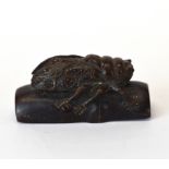 A carved fruitwood Netsuke of a cicada on bamboo with inset mother of pearl signature panel, L.