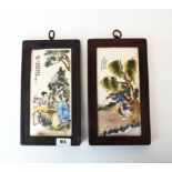 A pair of Chinese wooden framed porcelain panels, 16 x 29cm.