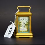 A miniature gilt brass carriage clock with Sevres style porcelain panels and face, appears to be