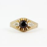 A hallmarked 9ct yellow gold ring set with a round cut garnet and diamond set shoulders, (O).