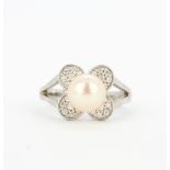 An 18ct white gold ring set with a freshwater pearl and diamonds, (M).