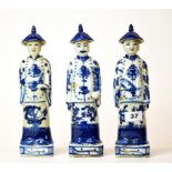 A set of three Chinese blue and white porcelain figures of mandarin, H. 28cm.