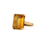 A 9ct yellow gold ring set with a large baguette cut citrine, (K).