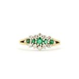 A hallmarked 9ct yellow gold ring set with round cut emeralds and brilliant cut diamonds, (M).