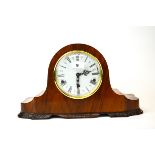 An attractive 1940's walnut veneered chiming mantle clock with carved mahogany foot decoration, H.