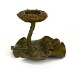 A small bronze candlestick of a frog on a lilypad, H. 6cm, Dia. 7.5cm.