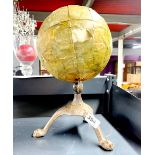An interesting globe on a cast iron base, H. 36cm.