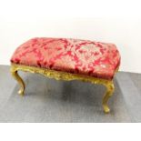 A large upholstered gilt carved wooden Victorian stool, W. 106cm.