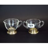 A vintage glass sugar bowl and milk jug with white metal feet (tested sterling silver), H. 6.5cm.
