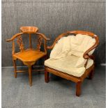 A Chinese carved hardwood horse shoe backed armchair with cushions, together with similar carved