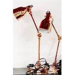 A pair of contemporary copperised anglepoise lamps.