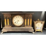 A Koma torsion pendulum mantel clock with a Victorian mantel clock.