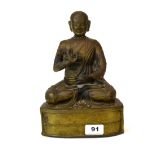A 19th / early 20th century Himalayan bronze figure of a seated Buddhist Lama, H. 25cm.