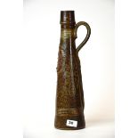 An interesting large signed French glazed pottery jug, H. 42cm (repaired).