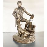 A cold cast figure of a gamekeeper with his dog by Heredities, entitled 'Taking a Break', H. 23cm.