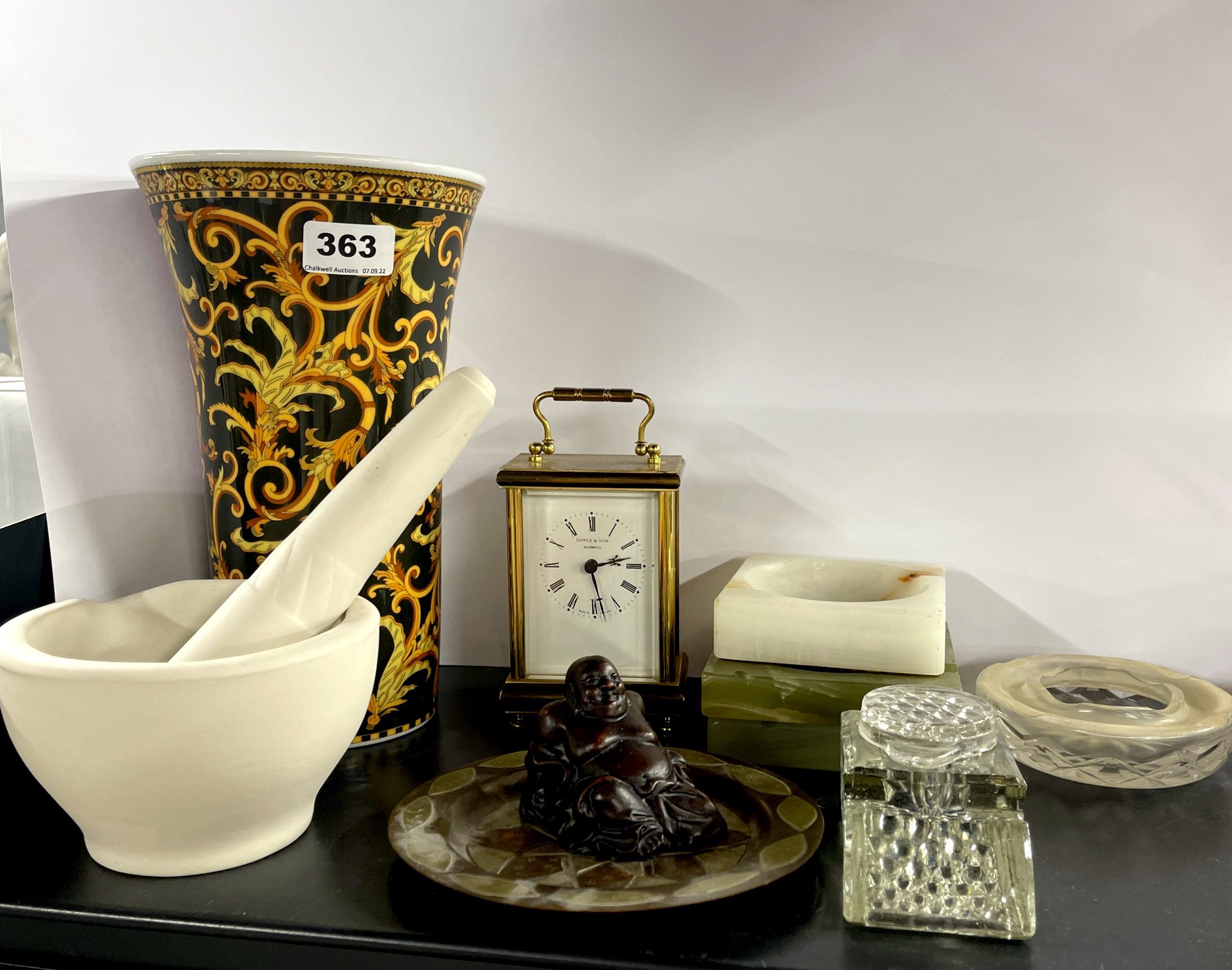 A Versace vase with a pestle and mortar and other items.