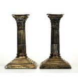 A pair of hallmarked silver column candlesticks, H. 15cm.