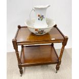 A vintage oak tea trolley with ceramic jug and bowl.