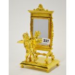 A gilt metal figure of a cherub standing in front of a mirror, H. 23cm.