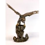 A silvered and gilt bronze figure of an eagle landing on rock, H. 50cm.