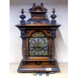 A 19th century striking carved walnut mantel clock, H. 49cm.