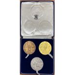 A boxed set of three 22ct gold, silver and bronze medallions commemorating the 900th anniversary