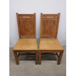 A pair of carved oak Ecclesiastical chairs, H. 96cm.
