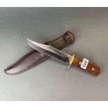 A Bowie knife and leather sheath, L. 31cm.