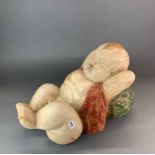 A large Chinese carved wood and painted figure of a baby boy, L. 50cm, H. 36cm.