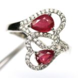 A 925 silver ring set with pear cut rubies and white stones, (O).