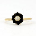 An 18ct and platinum (stamped 18ct and plat) mourning ring set with onyx and a pearl, (M).