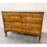 A lovely 1920's mahogany chest of drawers with concave and flame veneered drawers, W. 109cm, H.