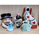 A Staffordshire dog figure with four Royal Doulton items.