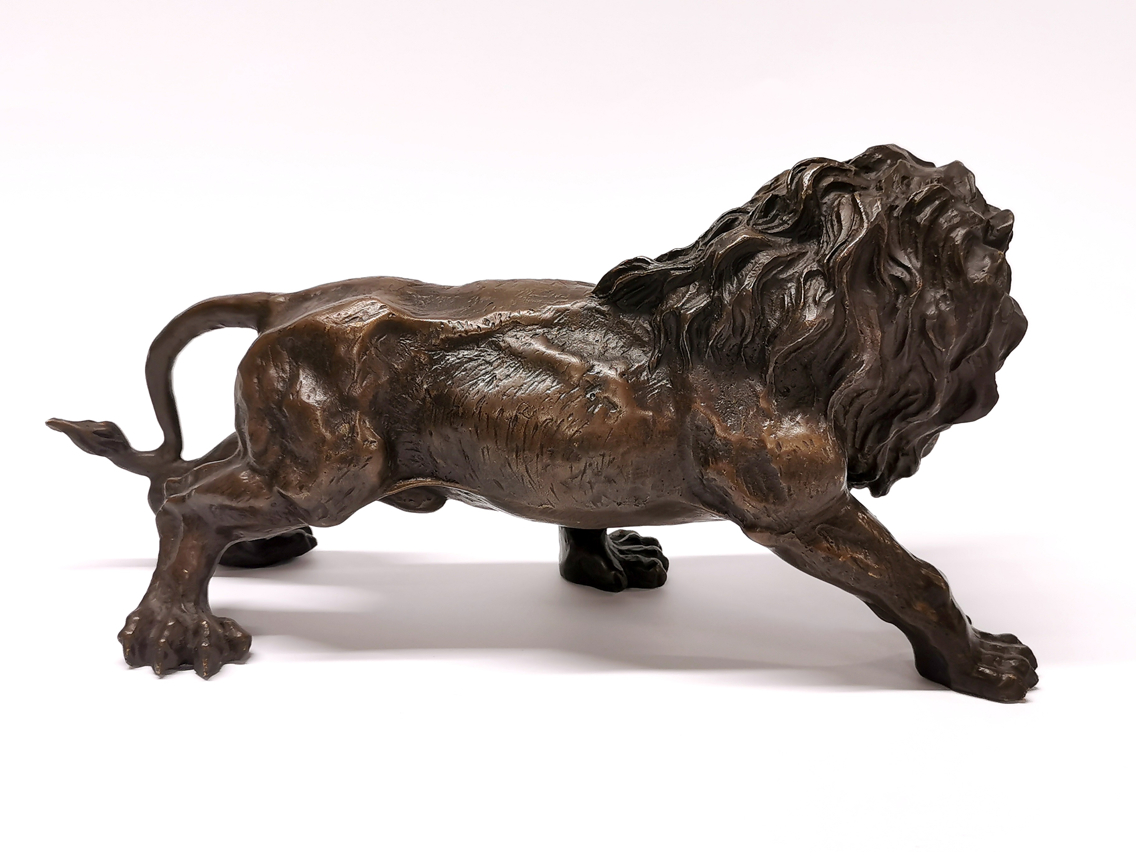 A cast bronze figure of a lion, H. 15cm, L. 30cm. - Image 2 of 3