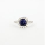 A 925 silver revolving adjustable ring set with cushion cut sapphire and white stones.