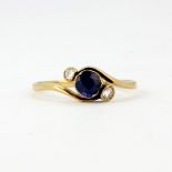 An antique 18ct yellow gold sapphire and diamond set crossover ring, (O).