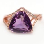 A rose gold on 925 silver ring set with a large trillion cut amethyst and white stones, (L.5).