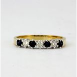 An 18ct yellow gold half eternity ring set with sapphires and diamonds, (O).