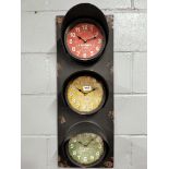 An interesting battery operated traffic light style metal triple wall clock, 30 x 80cm.