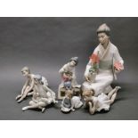 A Lladro figure of a Geisha with a vase of flowers, H. 19cm, together with a large Nao porcelain