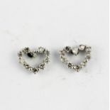 A pair of 18ct white gold diamond set heart shaped stud earrings, L. 0.7cm.