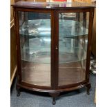 A useful mahogany bow front display cabinet with bevelled glass doors, H. 108cm, W. 93cm.