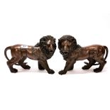 A pair of large bronze figures of lions, H. 23cm, L. 32cm.