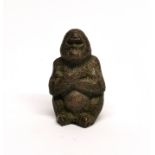 A small Chinese signed cast bronze figure of an ape, H. 5cm.