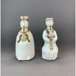 A pair of Chinese celadon glazed porcelain figural wine jugs, H. 19cm.