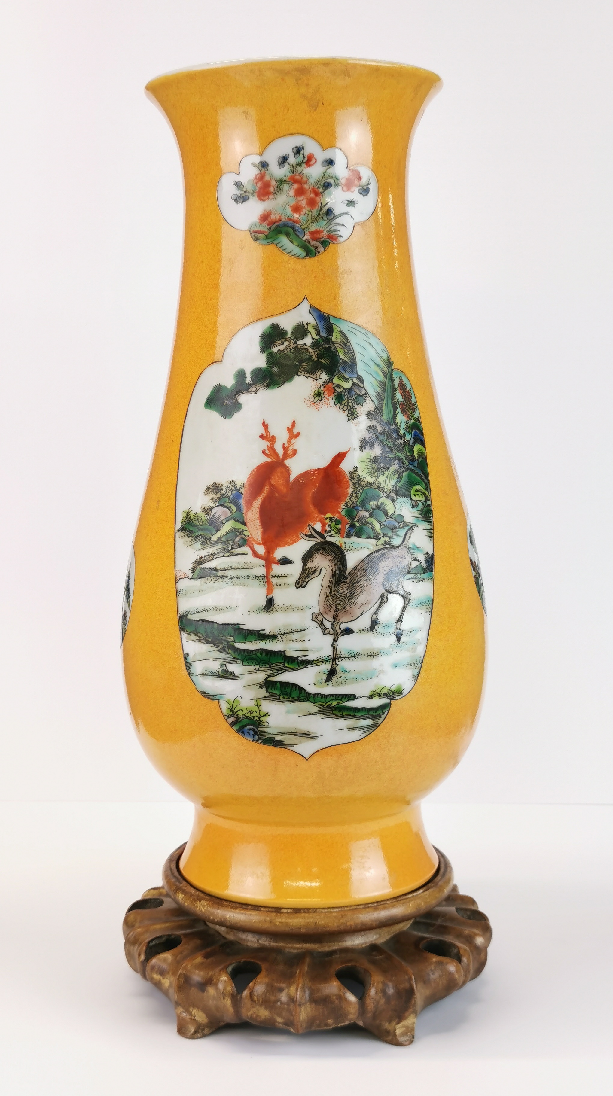 An impressive Chinese hand painted porcelain vase, H. 42cm, on a carved wooden base.