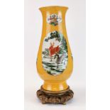 An impressive Chinese hand painted porcelain vase, H. 42cm, on a carved wooden base.