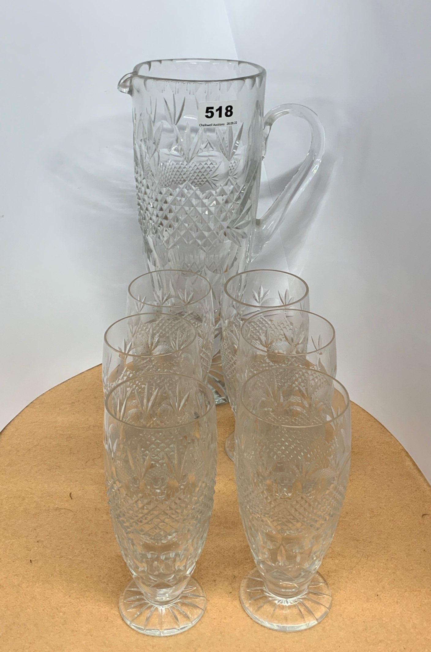 A fine cut glass water jug with six matching tumblers, jug H. 31cm.