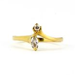 A yellow metal (tested 18ct gold) ring set with a marquise and a brilliant cut diamonds, (N).